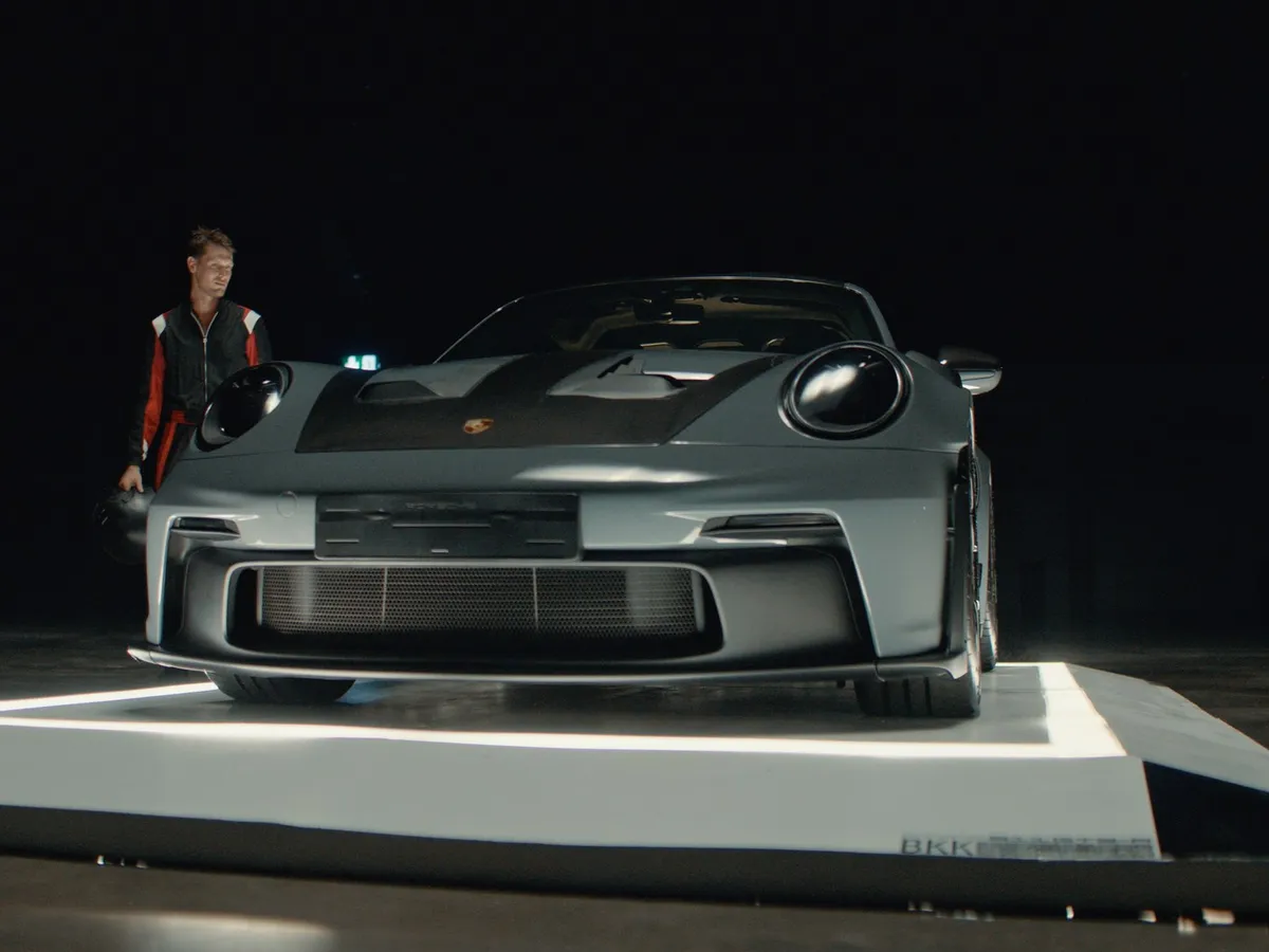 The Lollipop Racing Porsche 911 GT3 RS on a lit platform, from Episode Zero