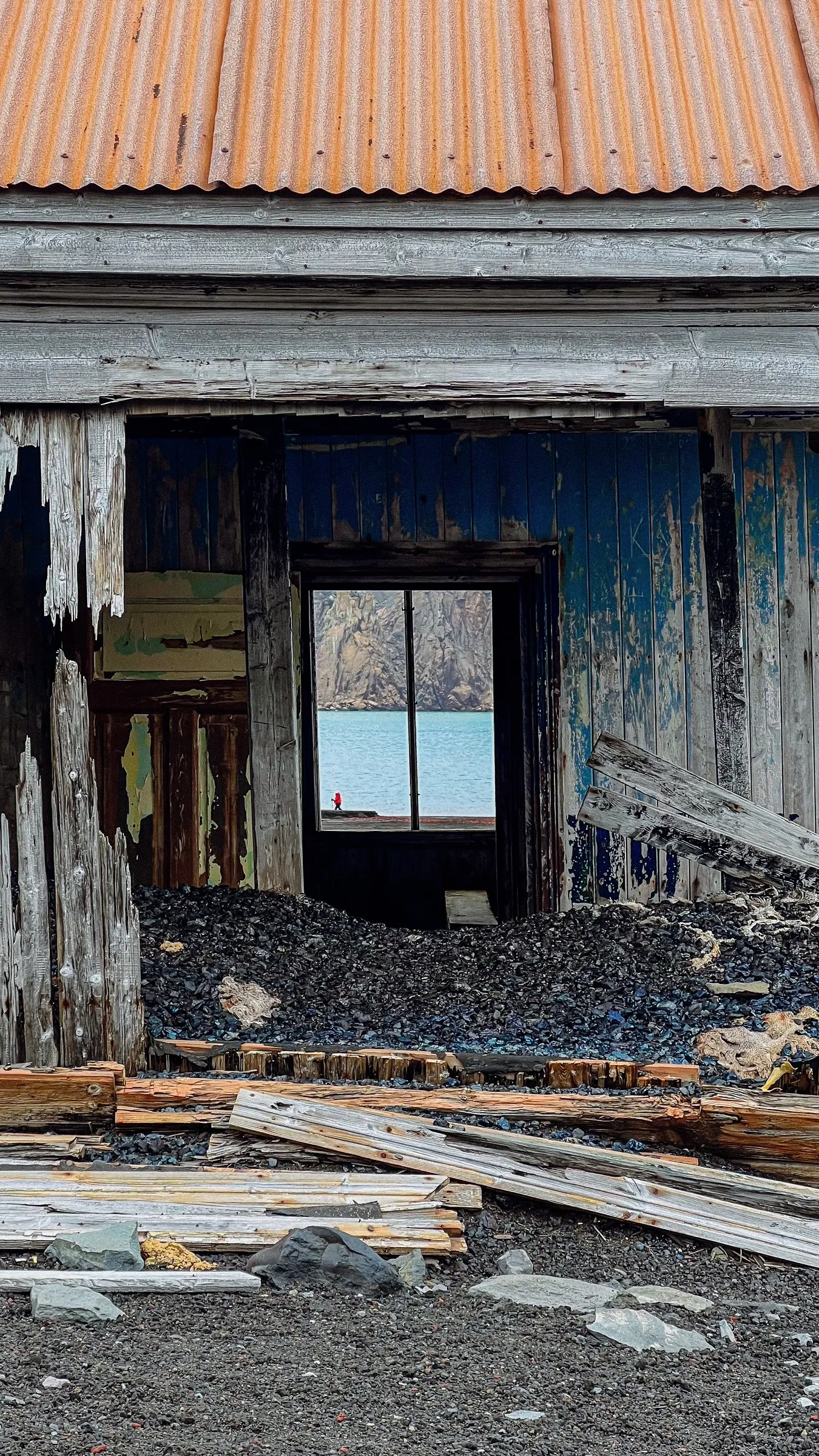 The bay seen through the doorway of a ruined whaling station